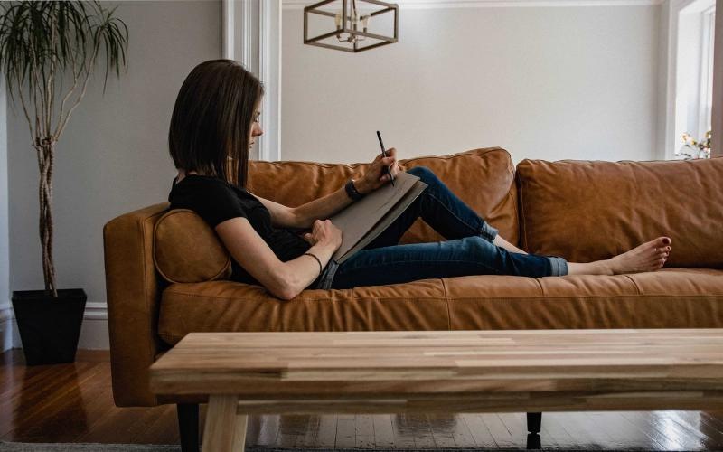 a person sitting on a couch with a cat